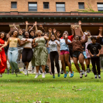 Cornell TASS students jump for joy on the Telluride House lawn